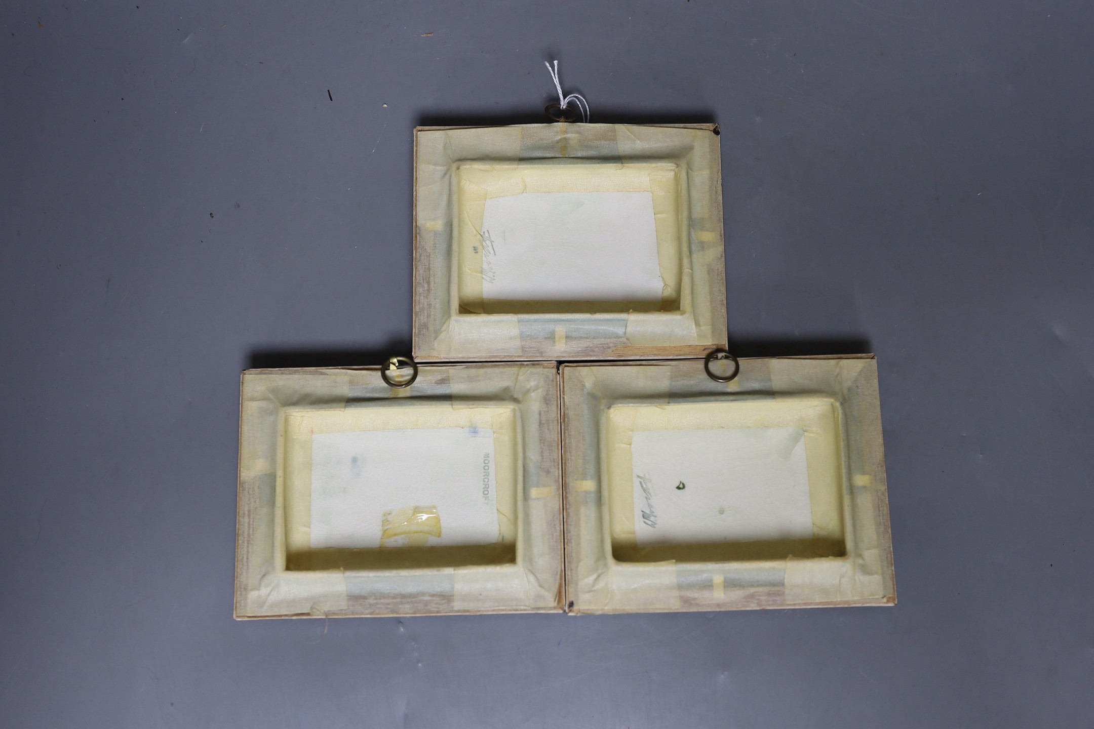 Three Moorcroft flower decorated plaques, impressed marks verso. 11.5 x 14cm